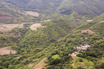 Forest landscape and a small village. The landscape in Armenia (Tatev). Forest in mountains top view.