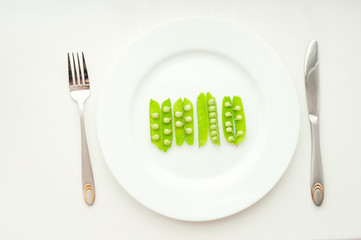 Peas in beans on white plate