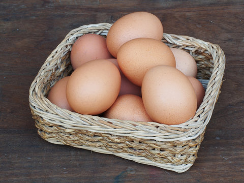 eggs in a basket wooden background