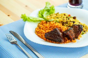 Dish of roast beef with rice and salad leaves