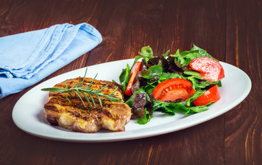 Grilled steak meat with salad from baked pepper
