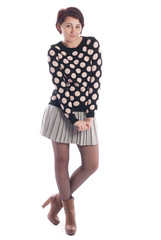 Beautiful young girl in a blouse and skirt on a white background.