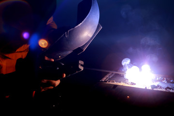 Fototapeta na wymiar Close-up of welder working in workshop.
