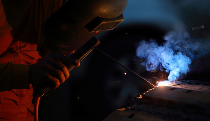 Close-up of welder working in workshop.