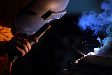 Close-up of welder working in workshop.