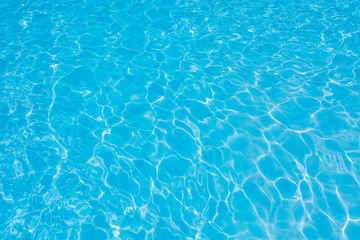 Fototapeta na wymiar Ripple water in swimming pool with sun reflection