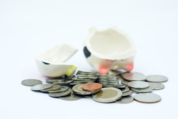 Thai stack coins with broken piggy bank on white background