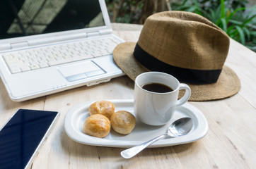 laptop,smartphone,hat and coffee on the table