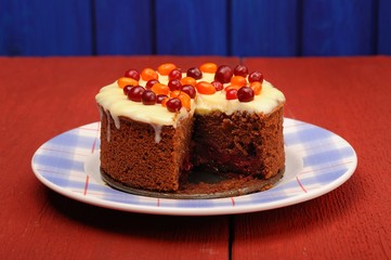 Homemade chocolate cake with fresh cranberries, sea-buckthorn an