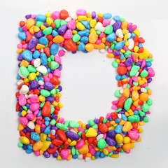 Obraz premium Colored stones arranged in a letter D.