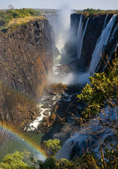 Victoria Falls. A general view of a rainbow. National park. Mosi-oa-Tunya National park. and World Heritage Site. Zambiya. Zimbabwe. An excellent illustration.