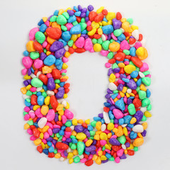 Colored stones arranged in a letter O.