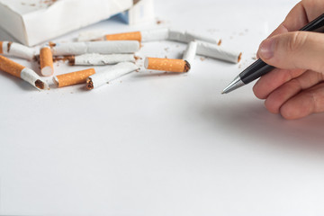 Anti-smoking background with heap of broken cigarettes