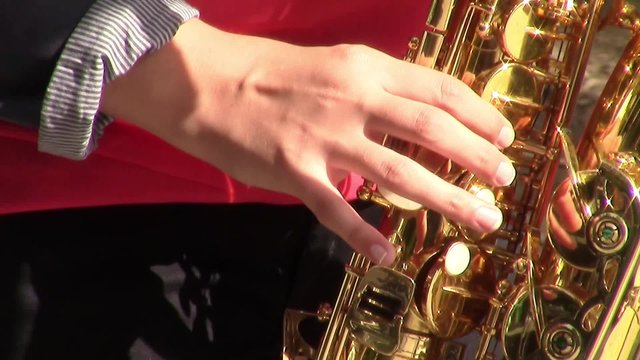 Musician's  female hand playing on saxophone  during a musical performance