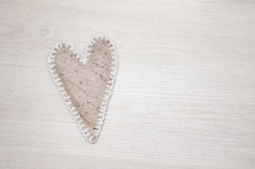 Self made linen heart on wooden background