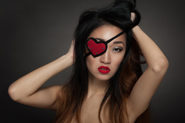 Fototapeta premium Woman with heart shape eye patch