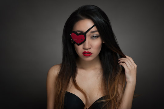 Woman with heart shape eye patch