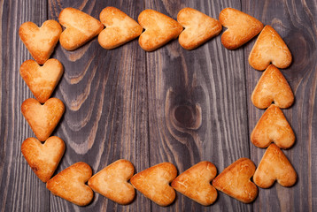 frame from heart shaped cookies on wooden table