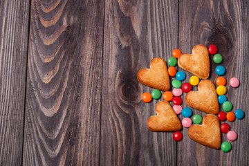 heap from candies and cookies on wooden background