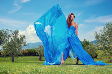  woman in blue dress on Tuscany hills