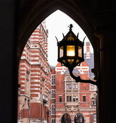 London Royal Courts of Justice Buildings through Arch and Street Lamp