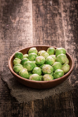 Fresh brussel sprouts over rustic wooden texture.healthy food