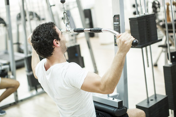 Fototapeta premium Young man training in the gym