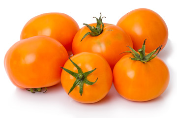 Ripe orange tomatoes on a white