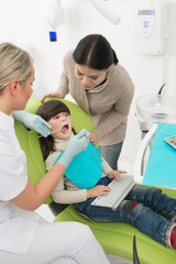 Little girl with her mother at dentist's office