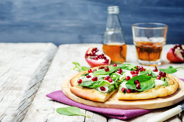 spinach pesto mozzarella onion pomegranate pizza