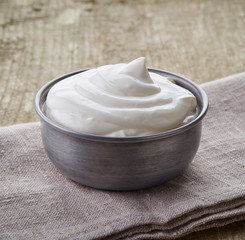 Bowl of cream on wooden table