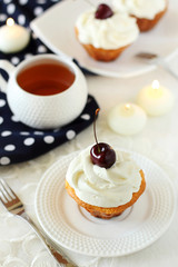 cupcakes with whipped cream and cherry