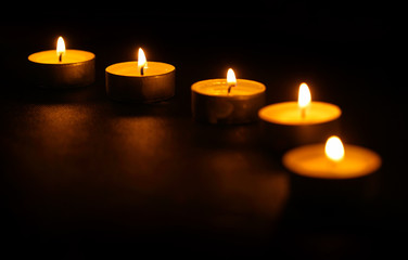 Five candles in line at dark