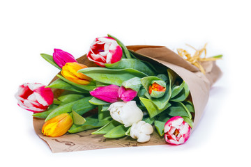 the bouquet of tulips is wrapped in a paper isolated on a white