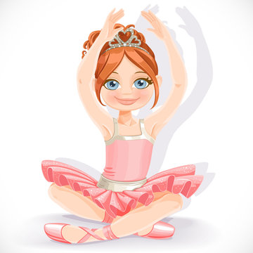 Ballerina girl in pink dress sit on floor isolated on a white background