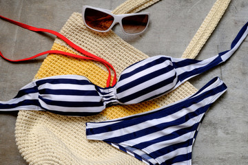 striped swimsuit and sunglasses