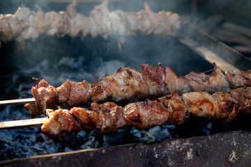 Grilling marinated shashlik on a grill