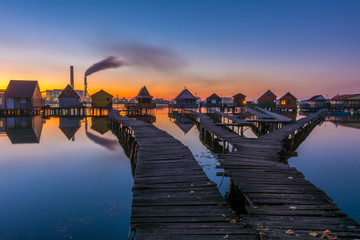 Small fishing cottages in the sunset on Bokod lake in Hungary