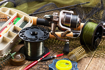 fishing tackle on a wooden table. toned image
