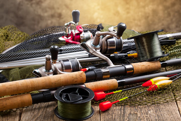 fishing tackle on a wooden table. toned image
