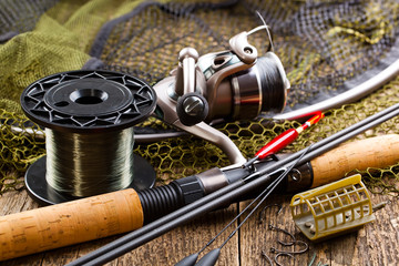 fishing tackle on a wooden table. toned image
