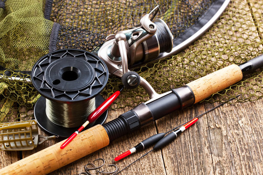 fishing tackle on a wooden table. toned image
