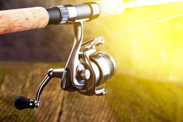 Obraz premium fishing tackle on a wooden table. toned image 