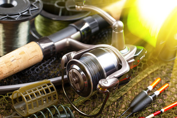 fishing tackle on a wooden table. toned image