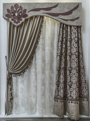 The beautiful, combined curtains. An openwork tulle and a hard pelmet with a contrasting applique