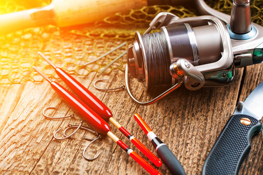 fishing tackle on a wooden table. toned image