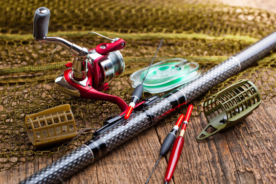 fishing tackle on a wooden table. toned image