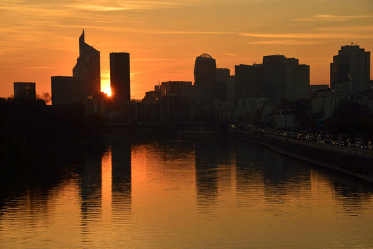Sunset over La D&eacute;fense business district and Seine river near Paris, France. 