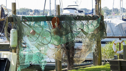 Fishing nets and fish traps on drying on a wooden rack.