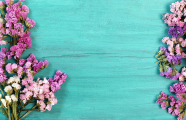 Naklejka na ściany i meble Beautiful flowers on green wood.